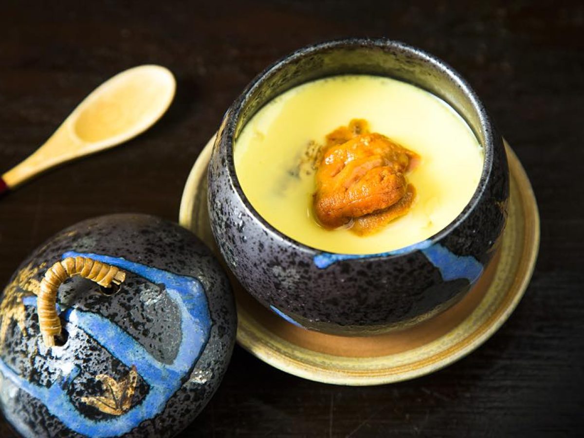 Sea Urchin Chawanmushi in a dish with chopsticks isolated on mat